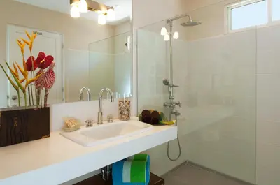 a white bathroom with a sink and a shower at The Breeze Hotel & Villas in Tamarindo