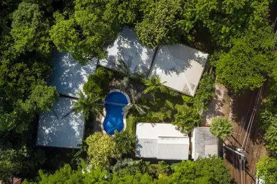an overhead view of a house with trees and a blue object at The Breeze Hotel & Villas in Tamarindo