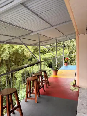 a row of tables and stools on a patio at Hospedaje Angeluz in Quesada
