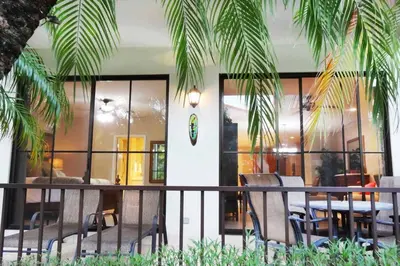 a balcony of a restaurant with chairs and a table at Ground-Floor Unit in Front of Lazy River Pool at Pacifico in Coco in Coco