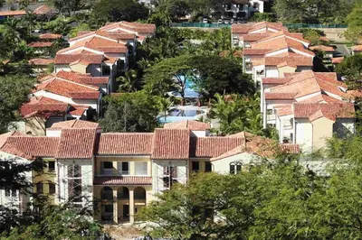 an aerial view of houses with red roofs at Ground-Floor Unit in Front of Lazy River Pool at Pacifico in Coco in Coco