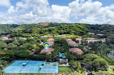 an aerial view of a resort with a tennis court at Ground-Floor Unit in Front of Lazy River Pool at Pacifico in Coco in Coco