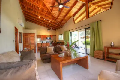 a living room with a couch and a table at Hidden Palms in Nosara