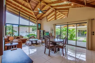 a living room with a table and chairs at Hidden Palms in Nosara