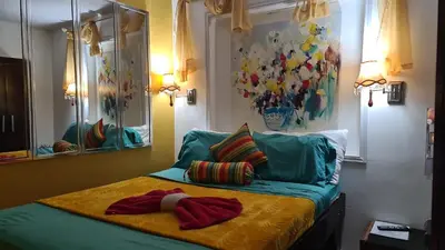 a bed with two pillows on it in a room at El Encanto Condominiums in Jacó