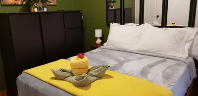 a bed with a chicken sitting on top of it at El Encanto Condominiums in Jacó