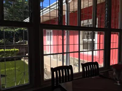 a view from a window of a red building at Hotel Hacienda El Rodeo in Rodeo