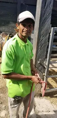 a woman in a green shirt holding a piece of meat at Hotel Hacienda El Rodeo in Rodeo