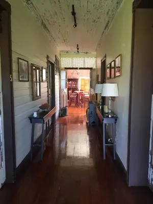 a hallway of a house with two tables and a dining room at Hotel Hacienda El Rodeo in Rodeo
