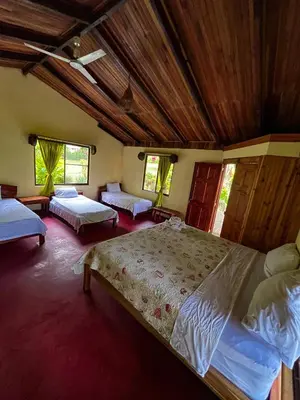 a bedroom with two beds and a ceiling at Princesa de la Luna Ecolodge in Fortuna