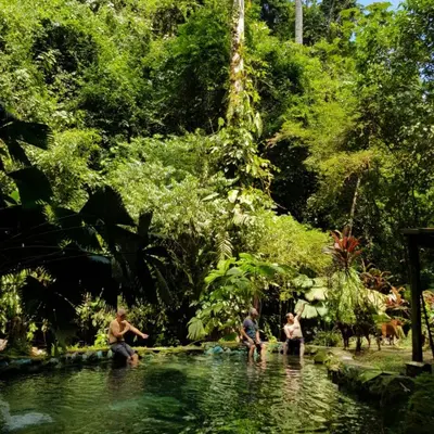 a group of people in the water in a pond at Princesa de la Luna Ecolodge in Fortuna
