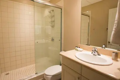 a bathroom with a sink and a shower and a toilet at Colorful 3-BD Unit Opening on Pool in Coco