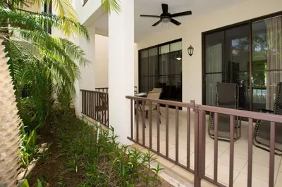 a balcony of a house with a ceiling fan at Colorful 3-BD Unit Opening on Pool in Coco