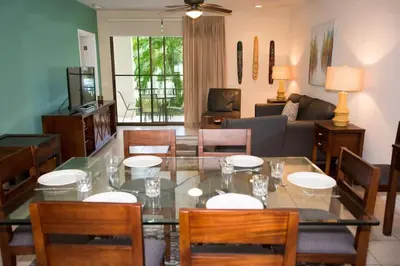 a living room with a glass table and chairs at Colorful 3-BD Unit Opening on Pool in Coco
