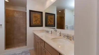 a bathroom with a sink and a shower at 1-Bedroom Near Pool in Coco