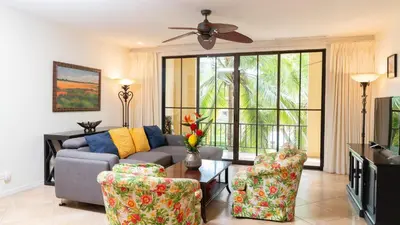 a living room with a couch and two chairs at 1-Bedroom Near Pool in Coco