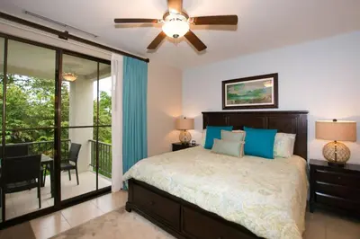 a bedroom with a bed and a ceiling fan at Nicely Decorated 3rd-Floor Beauty with Pool-View Balcony in Coco in Coco