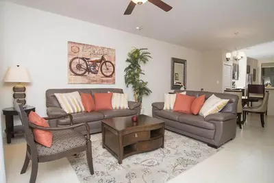 a living room with two couches and a table at Impressively designed and decorated 3rd-floor space overlooking pool in Coco in Coco