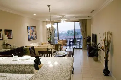 a living room with a couch and a table at Third-Floor Oceanview Condo with Access to Sparkling Pool, Hot Tub & Beach Club in Coco