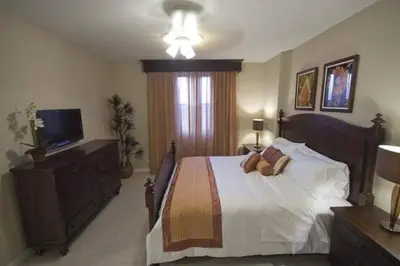 a bedroom with a large bed and a television at Third-Floor Oceanview Condo with Access to Sparkling Pool, Hot Tub & Beach Club in Coco