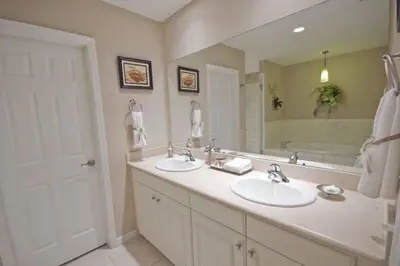 a bathroom with two sinks and a large mirror at Third-Floor Oceanview Condo with Access to Sparkling Pool, Hot Tub & Beach Club in Coco