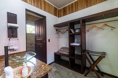 a bathroom with a glass table and a shower at Hotel Volcan Verde in Fortuna