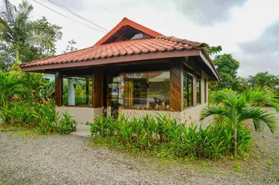 a small house with a red roof at Hotel Volcan Verde in Fortuna