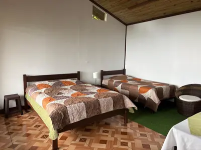 a bedroom with two beds in a room at Bella Vista Ranch Ecolodge in Turrialba