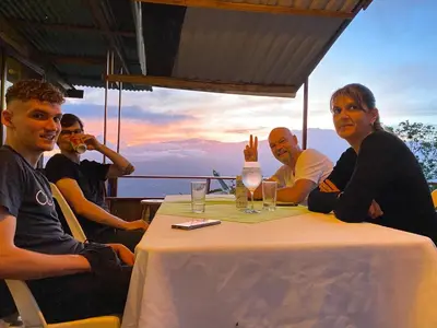 a group of people sitting around a table at Bella Vista Ranch Ecolodge in Turrialba