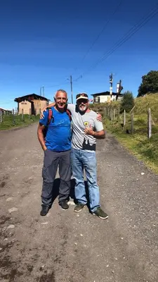 two men are standing on a dirt road at Bella Vista Ranch Ecolodge in Turrialba