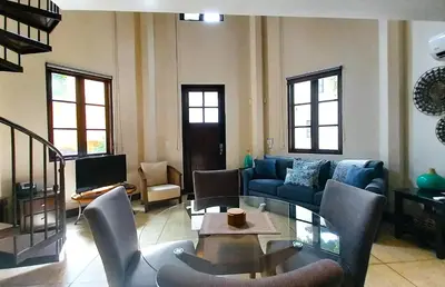 a living room with a couch and a table at Las Catalinas Loft - for up to 4 people just steps from the beach in Playa Danta