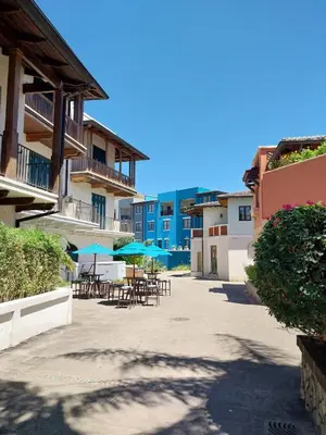 an empty courtyard with tables and umbrellas at Las Catalinas Loft - for up to 4 people just steps from the beach in Playa Danta