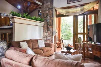 a living room with a couch and a television at Casa Cora Bed and Breakfast in Colonia Carmona