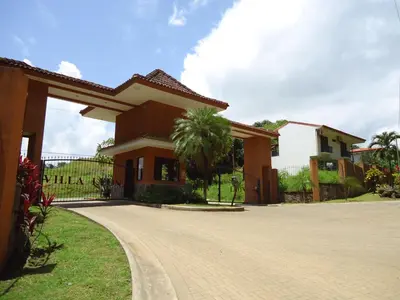 a house with a driveway in front of it at Punta Leona Beach Condos in Jacó