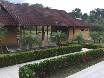 a building with a bunch of bushes and flowers at Punta Leona Beach Condos in Jacó