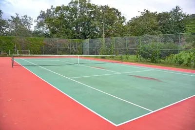 a tennis court with a net on top of it at Luxury Beach Apartment Herradura Fishermen And Family in Herradura