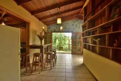 a kitchen with a dining room with a table and chairs at Mirador House Cozy & Private Home W Volcano View in El Castillo de la Fortuna