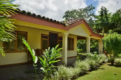 a small house with a yellow and red roof at Mirador House Cozy & Private Home W Volcano View in El Castillo de la Fortuna