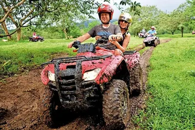 two people riding on a four wheeler on a dirt trail at Pie In The Sky 2 Luxury Home With Amazing Views! in El Castillo de La Fortuna