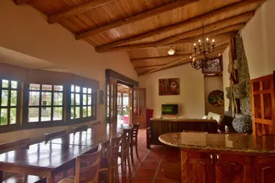 a living room with a table and a dining room at Pie In The Sky 3 Stunning Lake & Volcano Views! in El Castillo de La Fortuna