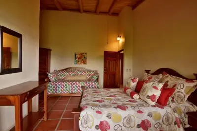 a bedroom with a bed and a desk at Pie In The Sky 3 Stunning Lake & Volcano Views! in El Castillo de La Fortuna