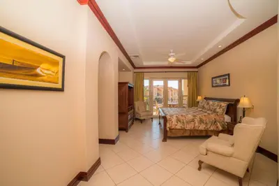 a bedroom with a bed and a table and chairs at Bella Vista 2C 3 bdrs pool view in Los Suenos in Herradura