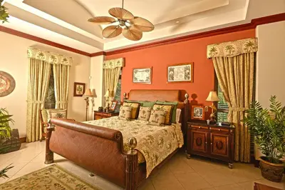 a bedroom with a bed and a ceiling fan at Bella Vista 4B 3 bdrs ocean view in Los Suenos in Herradura