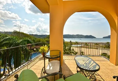 a balcony with chairs and a view of the ocean at Bella Vista 4B 3 bdrs ocean view in Los Suenos in Herradura
