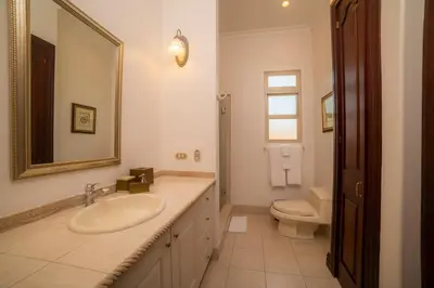 a bathroom with a sink and a toilet and a mirror at Bella Vista 2B 3 bdrs pool view in Los Suenos in Herradura