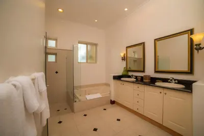 a bathroom with a shower and a sink and a mirror at Bella Vista 2B 3 bdrs pool view in Los Suenos in Herradura