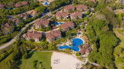 an aerial view of a mansion with a swimming pool at Bella Vista 2B 3 bdrs pool view in Los Suenos in Herradura