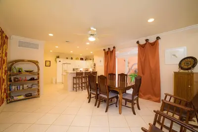 a dining room and kitchen with a table and chairs at Colina 9E 2 bdr Garden View in Los Suenos in Herradura