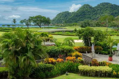 a view of a park with flowers and trees at Del Mar 3i 3 bdr Ocean View in Los Suenos in Herradura