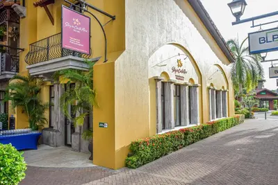 a yellow building with a sign on the side of it at Del Mar 3N 3 bdr Garden View in Los Suenos in Herradura
